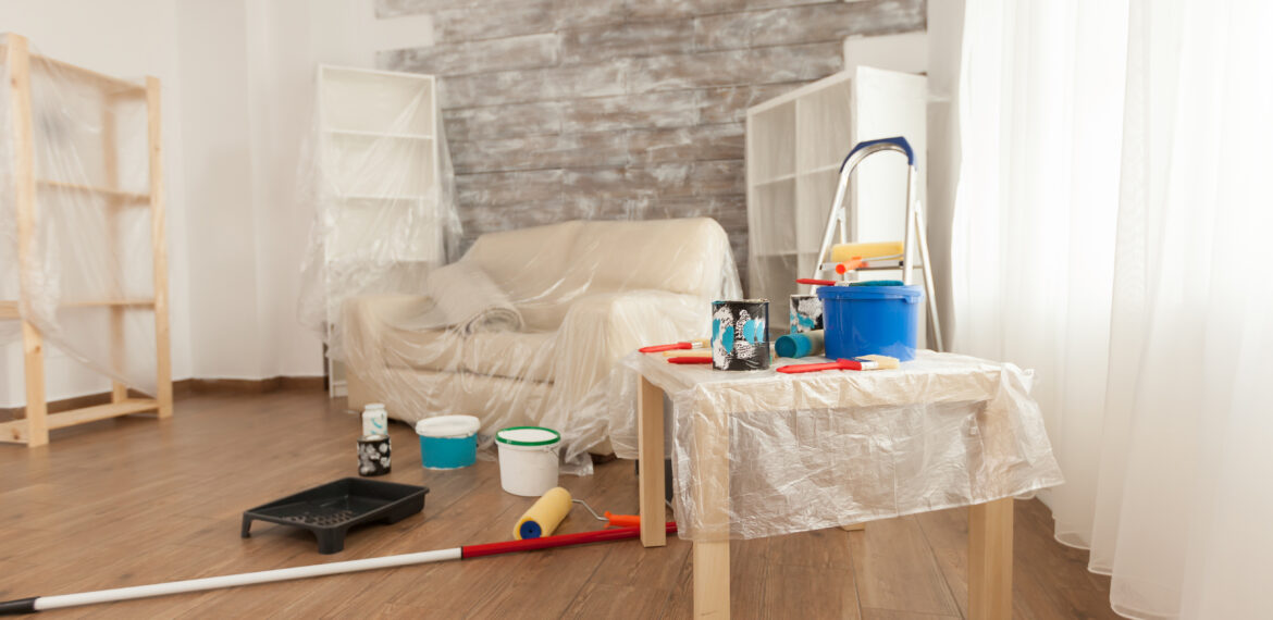 Tools ready for renovation placed on the floor of the room. Home during renovation, decoration and painting. Interior apartment improvement maintenance. Roller, ladder for house repair