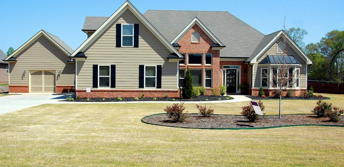 Spacious house with green lawn in front.