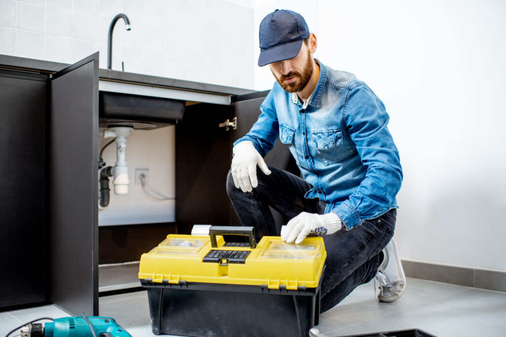 A repairman fixing kitchen furniture.